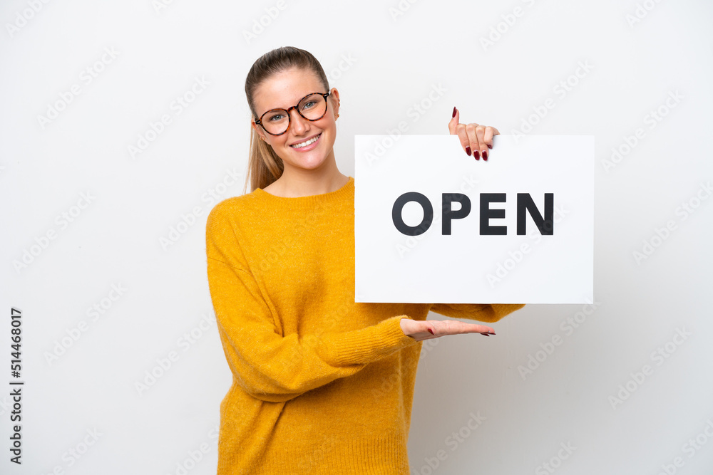Young caucasian woman isolated on white background holding a placard with text OPEN with happy expression Young caucasian woman isolated on white background holding a placard with text OPEN with happy expression