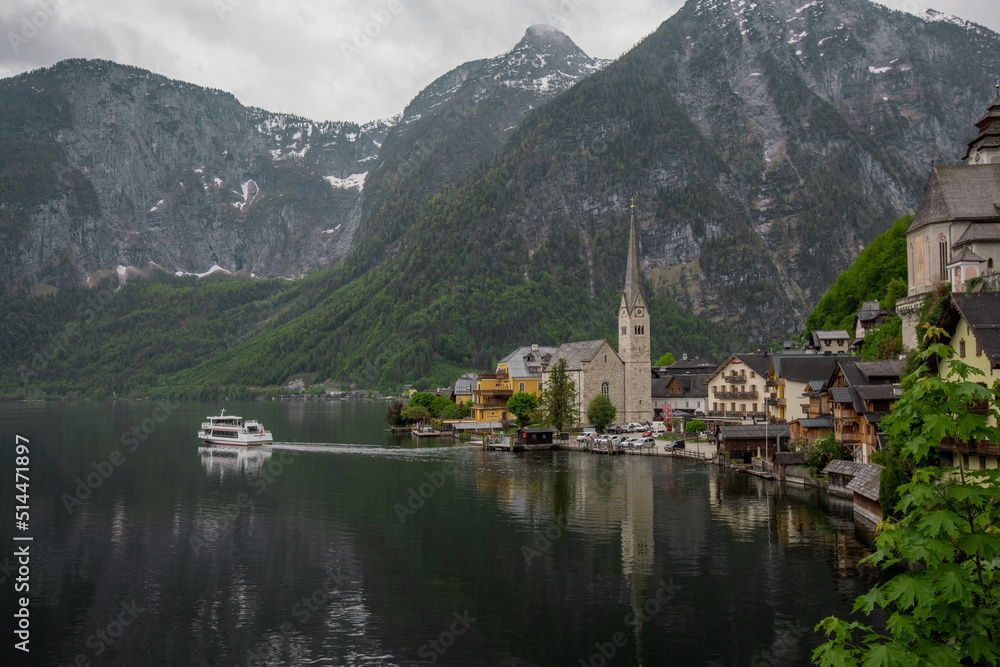 Beautiful view of Hallstatt, Austria, picturesque village on the edge of a lake. Classical view with one of the ships just departing.