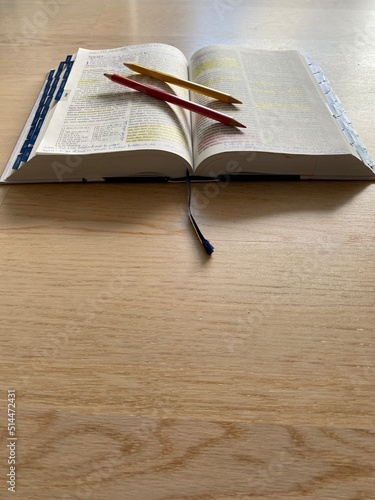 Open Bible flat lay on wooden floor with pencils  highlights and notes. Bible Study. Baselland  Switzerland - 01.07.2022