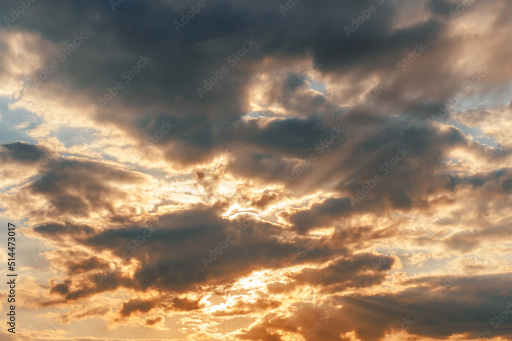 Fototapeta premium Dramatic sunset sky with burning golden clouds. Beautiful nature fluffy cloud background.