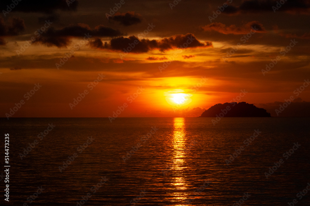 Colorful beach sunset view with island background. Copy space
