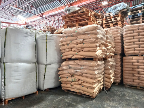 Chemical fertilizers Packed in stacked sacks with clear plastic wrapped around stacked on wooden pallets orderly. In the warehouse waiting for delivery