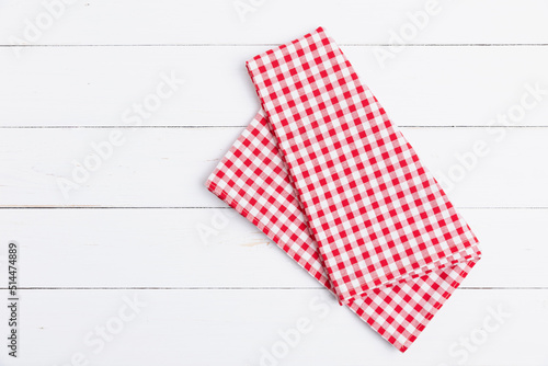 Fabric red and white tablecloth checkered on white the wood background. Top view, Flat lay cotton checkered with copy space.