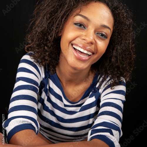 Striped top: laugh out loud. A moment of relaxed and natural laughter from a beautiful young girl. Part of a series of images with the same model.