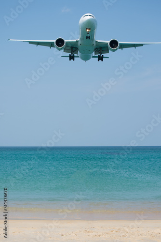 A plane is landing near white beach