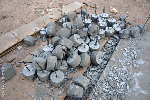 The pile of single concrete spacers round type on the ground  single cover spacer for the slabs.              