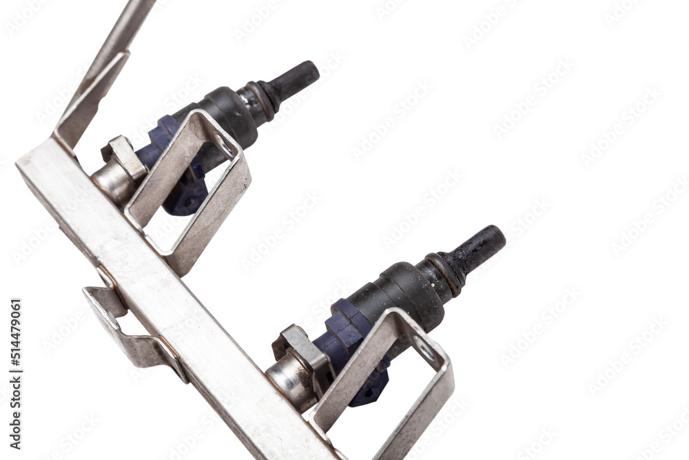 Close-up on a car fuel injector for supplying gasoline to cylinder engine on a white isolated background. Spare parts catalog Close-up on a car fuel injector for supplying gasoline to cylinder engine on a white isolated background. Spare parts catalog