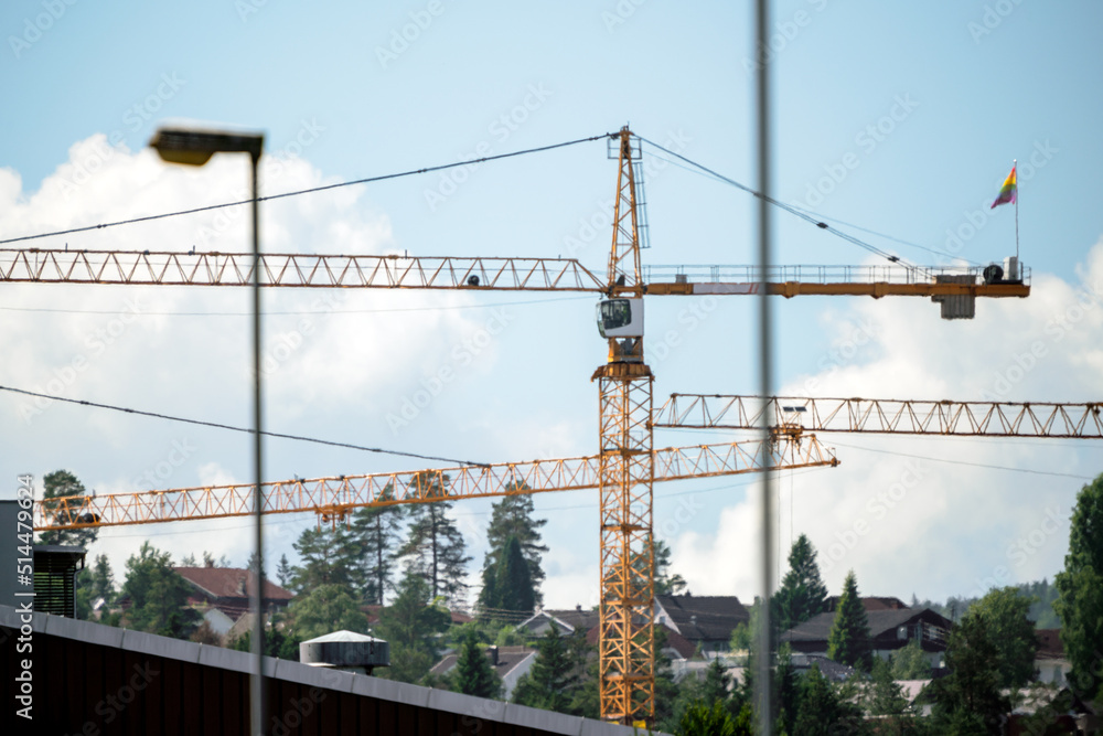 construction crane with the lgbtq flag on the back. construction crane with the lgbtq flag on the back.