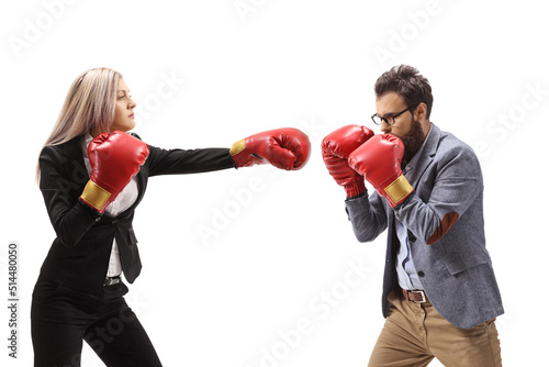 Fotografering Profile shot of a man and woman in formal clothes fighting with boxing gloves