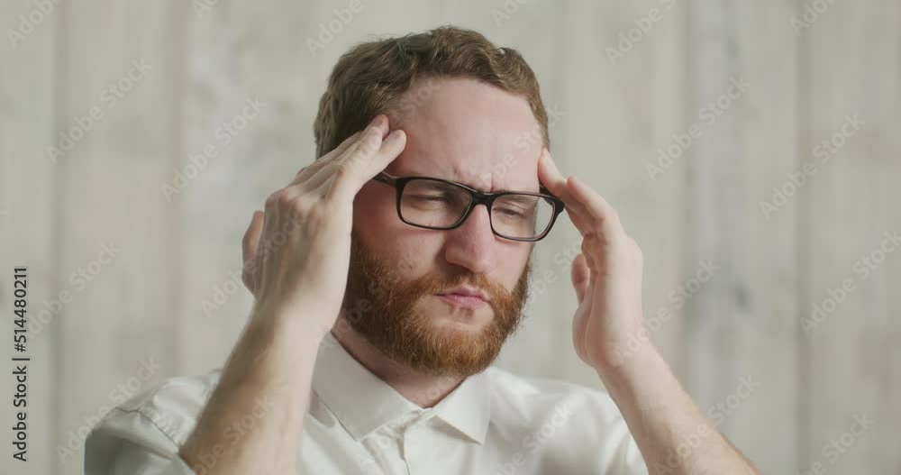 serious man with glasses and a headache. An office worker after a hard day. serious man with glasses and a headache. An office worker after a hard day.