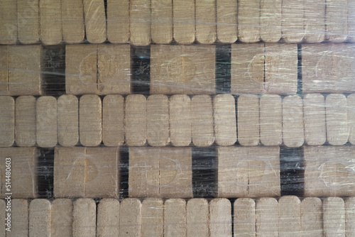 Картината върху платно Pressed pine wood briquettes on pallets