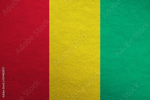 Modern shine leather background in colors of national flag. Guinea