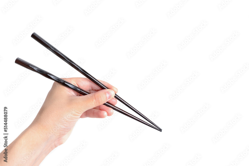 Hand holding black chopsticks isolated on white Hand holding black chopsticks isolated on white