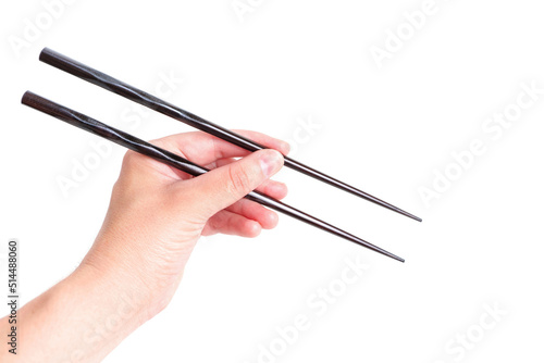 Wooden chopsticks in hand against white background