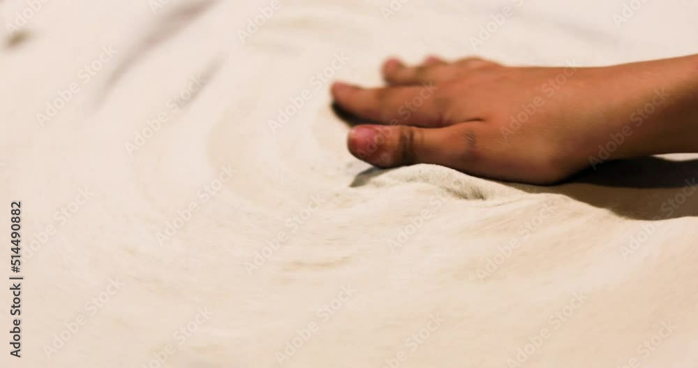 children's hand with fingers on a potter's wheel creates a pattern from the sand. Active family vacation, hobby children's hand with fingers on a potter's wheel creates a pattern from the sand. Active family vacation, hobby
