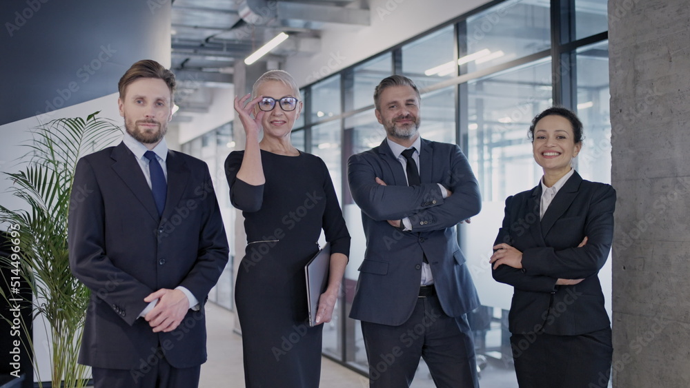 Team of professional managers smiling while posing on camera, ready to quality work Team of professional managers smiling while posing on camera, ready to quality work
