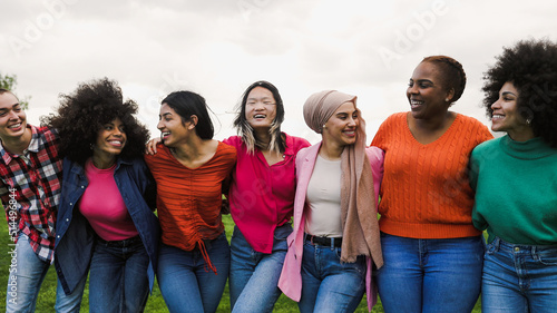 Happy young multi ethnic women having fun in a park - Diversity and friendship concept