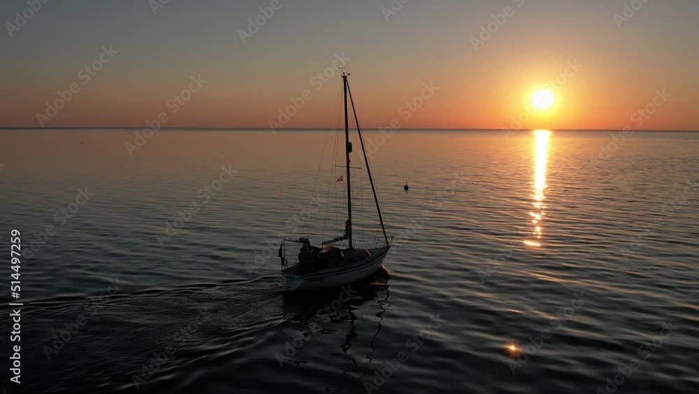 Aerial drone top view with copy space of luxury speed boat cruising in high speed in blue sea. Reflection of the sailing yatch and golden sunset in water. Leisure time at nautical vessel in the ocean Aerial drone top view with copy space of luxury speed boat cruising in high speed in blue sea. Reflection of the sailing yatch and golden sunset in water. Leisure time at nautical vessel in the ocean