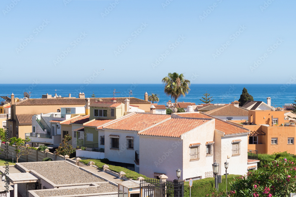 Residential area of wealthy families facing the Mediterranean coast. Quiet area called La Carihuela in Torremolinos (Spain). Two-storey villas or townhouses in a neighbourhood in front of the sea.