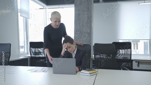 Strict lady boss critisizing sad female employee in office, stressful job, mistake