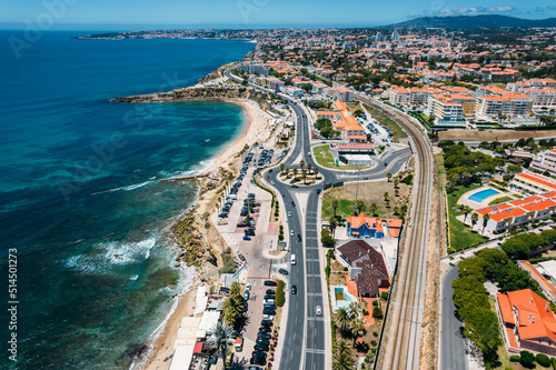 Aerial drone view of coastline hugging the Marginal Avenue with Sao Pedro de Estoril district in Greater Lisbon, Portugal photo