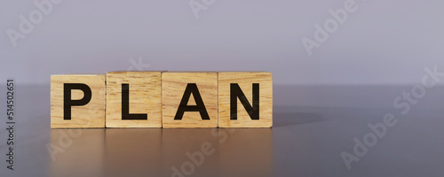 plan on wooden box on gray background,Doing business must have a plan to work towards the goal. photo