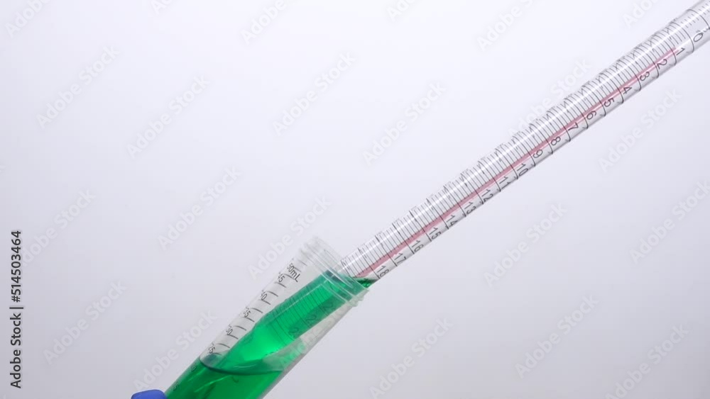 Withdraw green liquid from a laboratory tube using a chemical pipette Withdraw green liquid from a laboratory tube using a chemical pipette