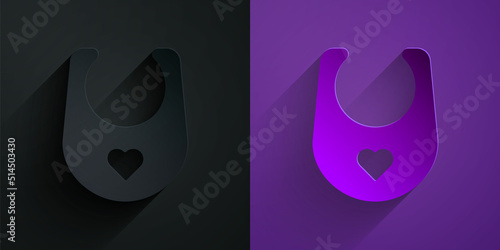 Paper cut Baby bib icon isolated on black on purple background. Paper art style. Vector