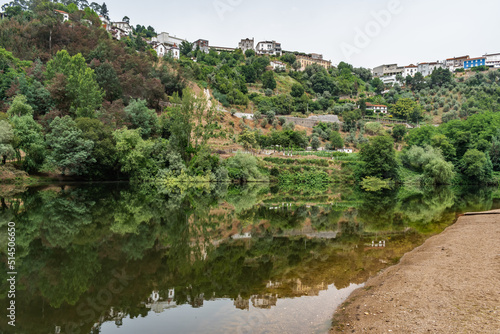 Sand next the river Mondego with mirror effect of trees on the bank and the hill, Penacova PORTUGAL