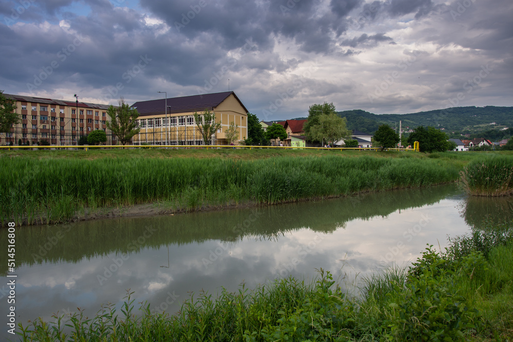 Fototapeta premium Romania, Bistrita, School near the Bistrita River in June 2022