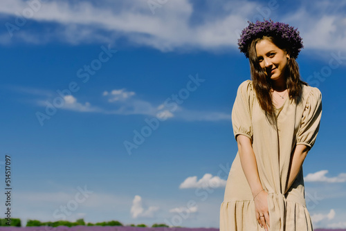 Woman with wreath of flowers in lavender field