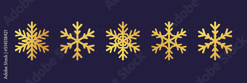 Golden snowflake. Icon of a snow flake made of a golden foil