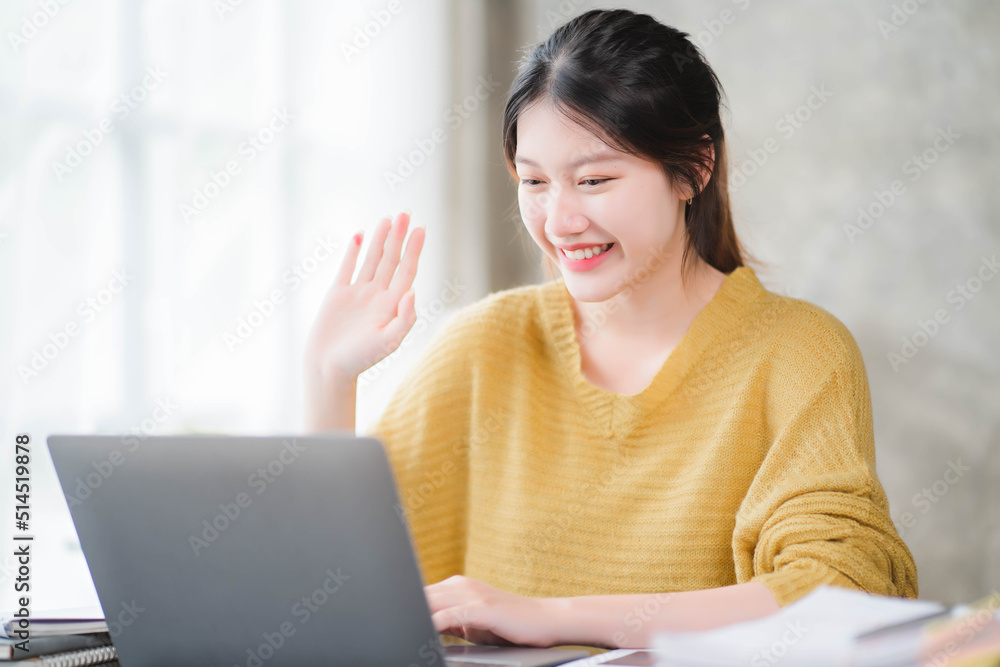 Smiling asian business woman sitting in a modern office Smiling asian business woman sitting in a modern office