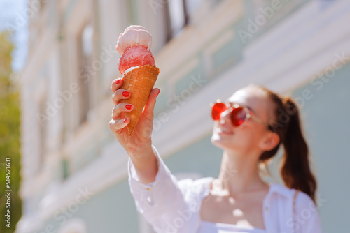 girl enjoying ice cream in a cone with ice cream balls