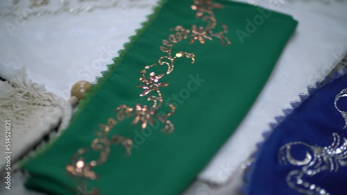 Close-up video shoot of a woman who does handicraft embroidery and the finished products she embroidered