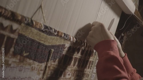 woman weaving a handmade carpet close-up