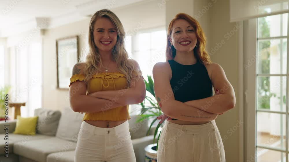 Two women smiling confident standing with arms crossed gesture at home Two women smiling confident standing with arms crossed gesture at home