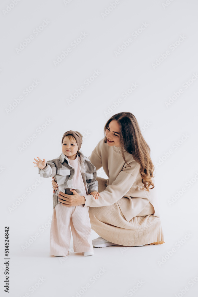 Mother, little daughter isolated on white background, studio portrait, mother's day, love, family, parenting, childhood, concept Mother, little daughter isolated on white background, studio portrait, mother's day, love, family, parenting, childhood, concept