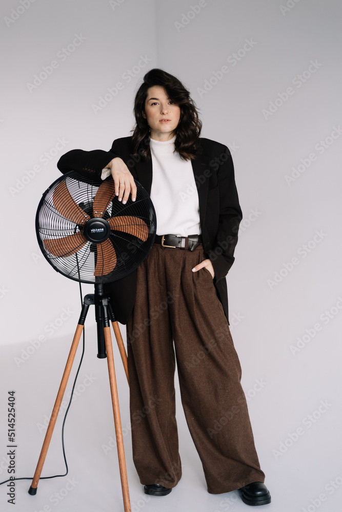 Attractive woman wear business look. Brunette model wear white shirt, black men's jacket and brown baggy pants. Winter, fall autumn or spring minimal outfit. Attractive woman wear business look. Brunette model wear white shirt, black men's jacket and brown baggy pants. Winter, fall autumn or spring minimal outfit.
