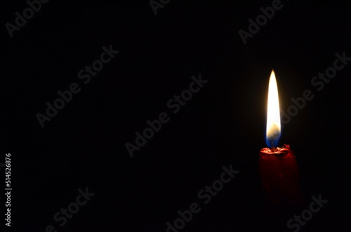 candle flame on a black background as a symbol of grief