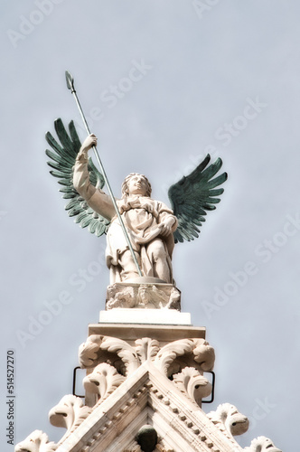 Statue atop a roof in Sienna, Italy