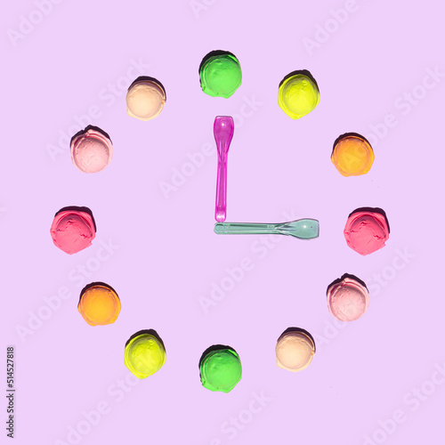 Colorful ice cream balls and spoons on light pastel purple background. Creative tasty food concept. Minimalistic sweets composition. Sunny summer idea.