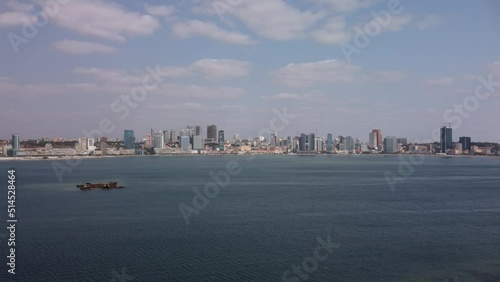 Aerial footage with Luanda Bay and Luanda city downtown, Modern skyscrapers buildings, boats and ships, Port, marina, marginal and central buildings, bay water, Angola photo