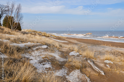 Fototapeta Naklejka Na Ścianę i Meble -  The sandy beach and winter shoreline as seen at Point Beach State Forest on Lake Michigan, Two Rivers, Wsconsin.