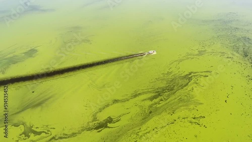 Above view from copter on the yacht smiwwing along the green river. photo