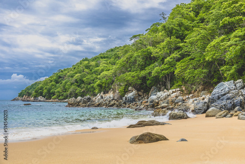 Huatulco bays - Maguey beach. Beautiful beach with pristine waters, with turtles and fishes. Mexican beach with wooden huts by the sea