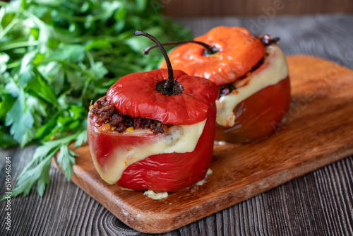 Stuffed pepper Rocoto relleno with baked meat and melted cheese on a wooden board photo