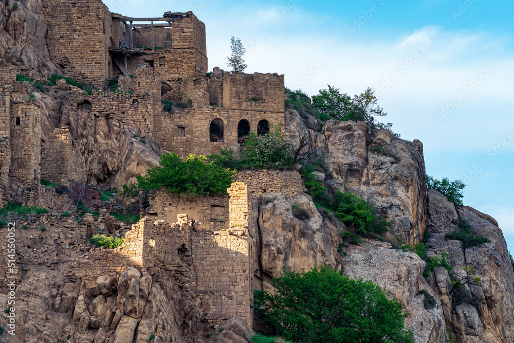 walls of abandoned houses on a mountain cliff in the ghost village of Gamsutl in Dagestan