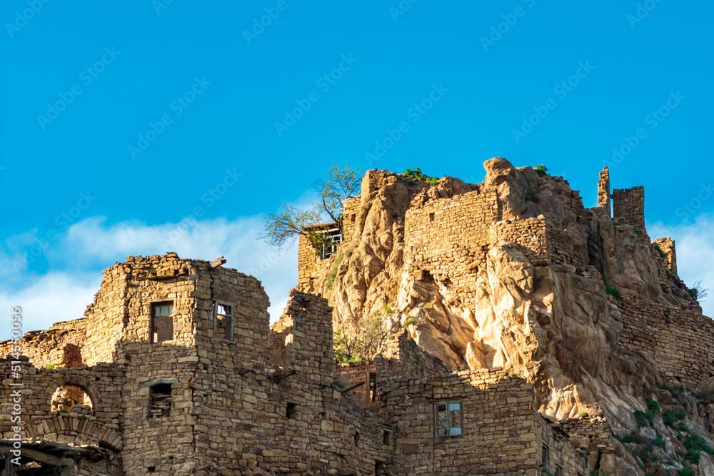 ruins of walls of houses on a cliff in the abandoned village of Gamsutl in Dagestan