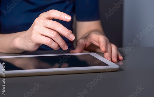 The hands of a businesswoman with a tablet